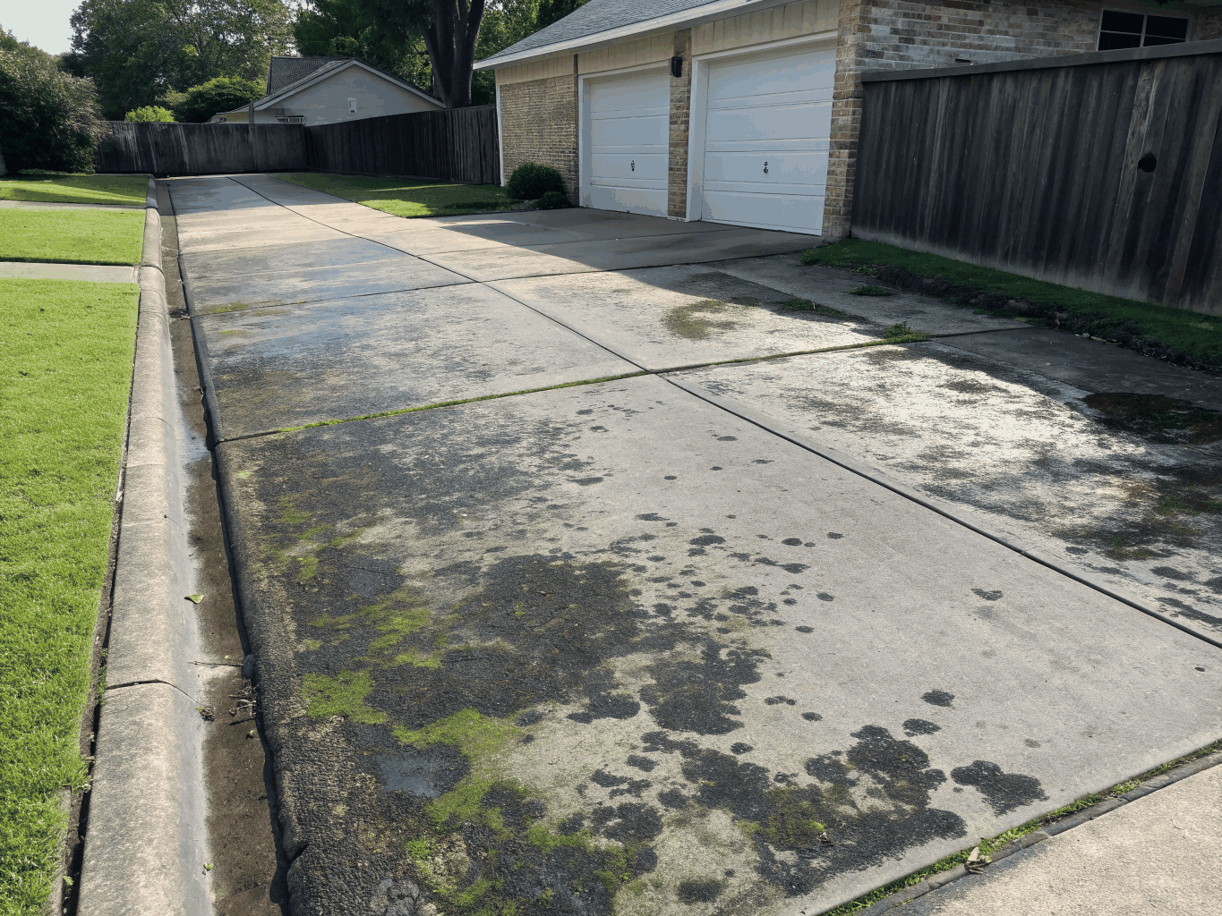 Concrete driveway with heavy surface grime before pressure washing