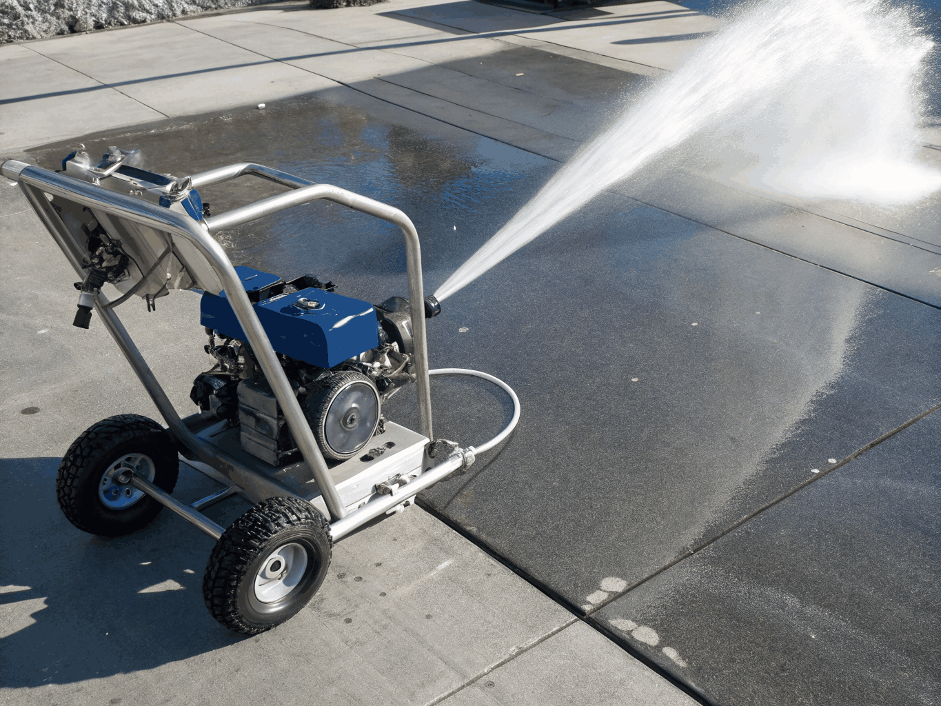 High pressure cleaning applied to a paved outdoor surface